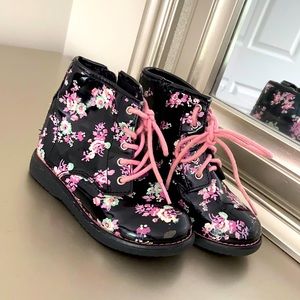 Pink and black shiny rain boots.